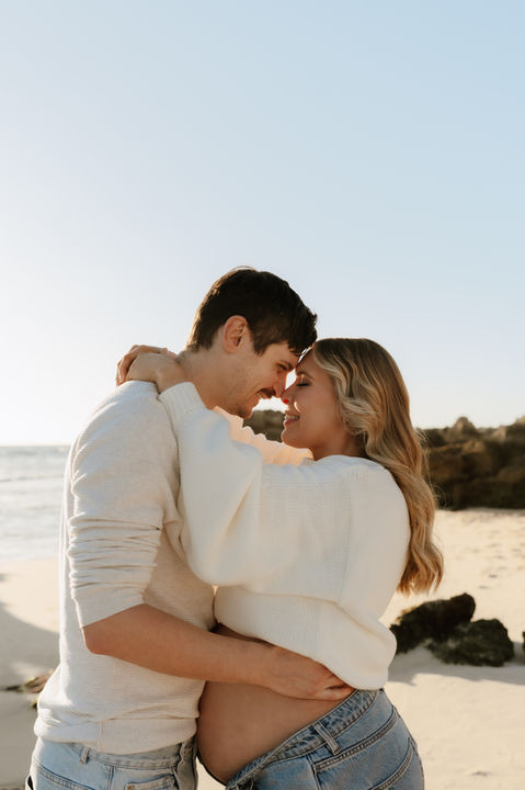 couple embracing during their maternal photography session 