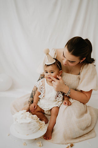 mother comforting one year old on birthday