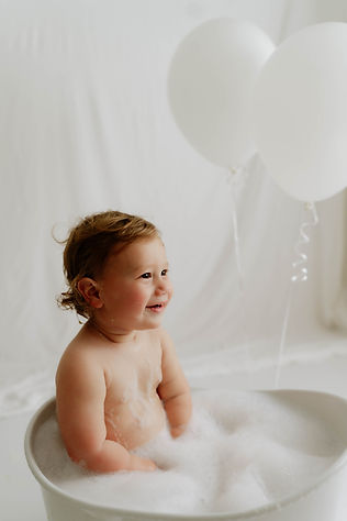 one year old birthday photo in bath