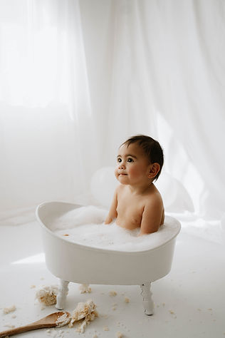 toddler in tiny bath during photoshoot