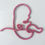 Thumbnail: a pink picture of a baby made with knitted wire art