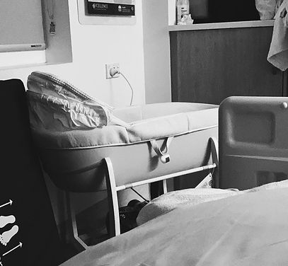 A black and white image of our cuddle cot from when we were in hospital with our still born twins. The photo is taken from the side/back and you cannot see the babies inside.