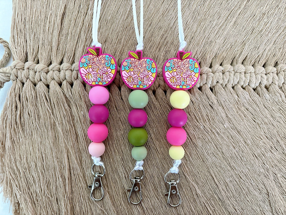 Teacher lanyards, pinks, greens and yellow colours. All with the same apple teacher focus bead, and a silver clasp.
