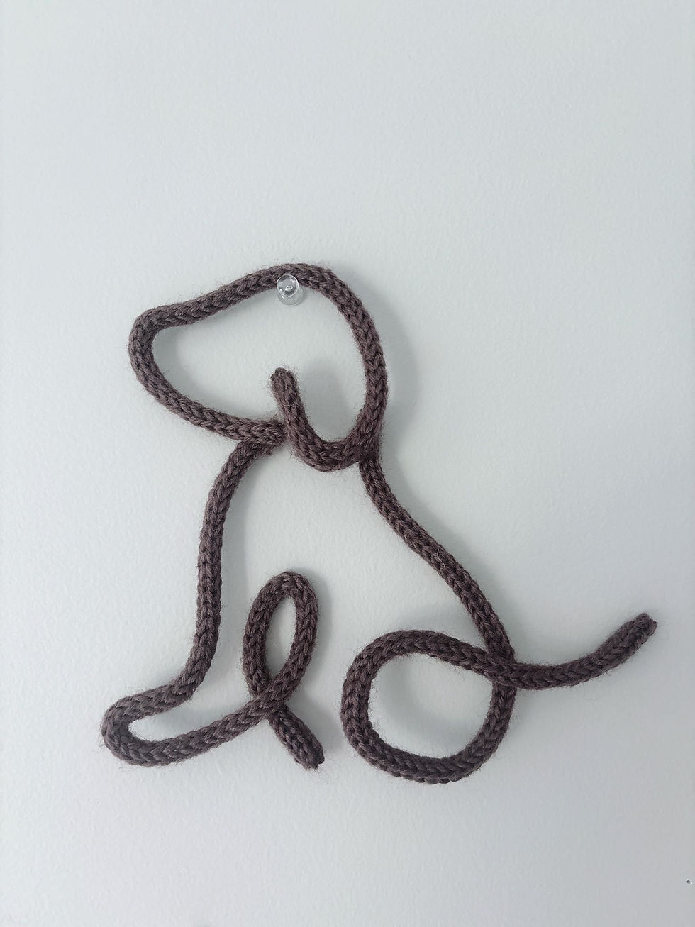 a brown dog in knitted wire