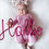 Thumbnail: a baby holding a pink knitted wire art name "hallie"
