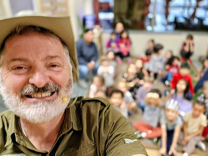 Magician, Kirby Romine smiles at the camera just before performing a magic show for a library
