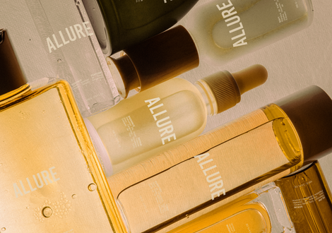 Skincare products with "ALLURE" branding, warm tones.