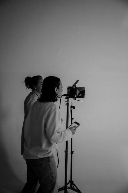 Two people operating a camera in a studio.