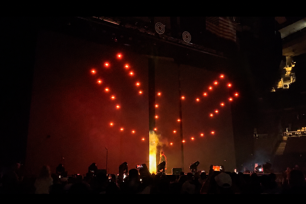 An indoor drone light show over an event crowd, by Illuminate Drones