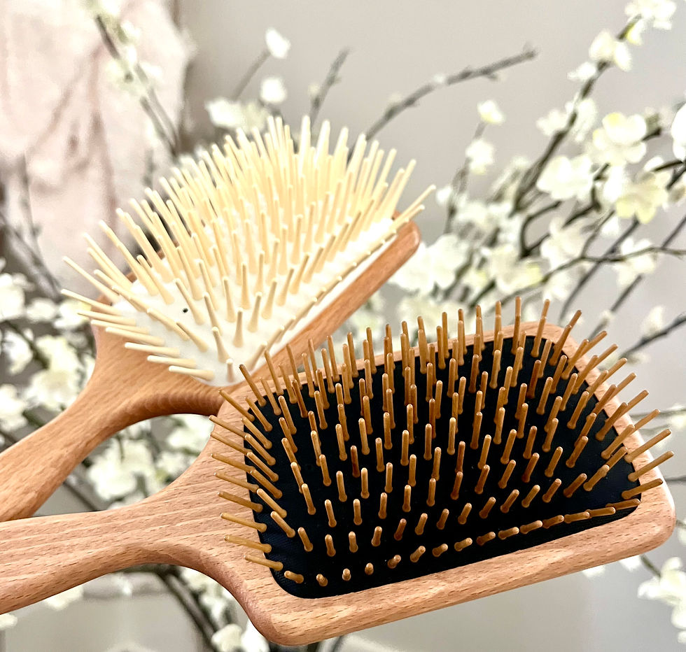 SHASH Wooden Paddle Brushes with flowers in backdrop. One medium size and one large size brush.