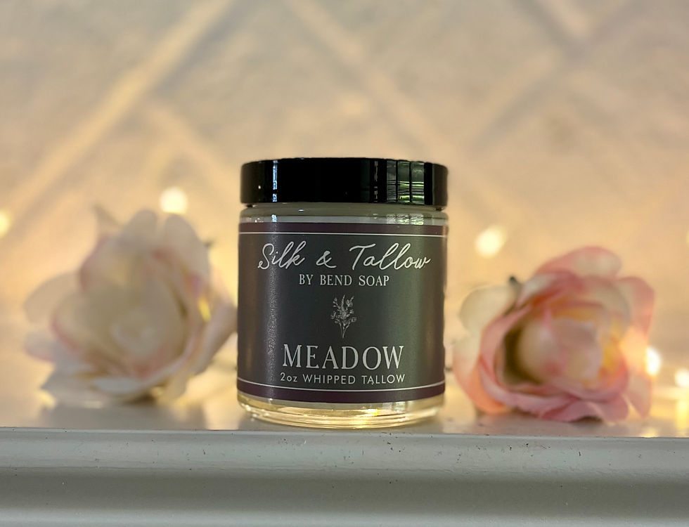 Bend Soap Co. Silk & Tallow Meadow scent. Front of jar with logo. Fairy lights, pink roses, & white brick backdrop.