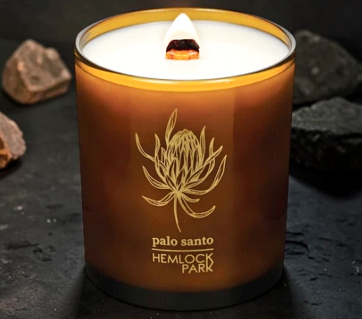 Hemlock Park Palo Santo Organic Coconut Wax Candle. Amber Glass jar with burning wood wick.