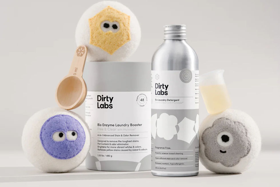 Dirty Labs logo aluminum Laundry Detergent bottle, Laundry Booster, and Wool Dryer Balls, scoop, and measuring beaker.