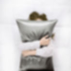 Promeed Organic Mulberry Silk Pillowcase Grey. Woman hugging pillow.