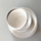 Stack of sparkling clean white dishes and bowls