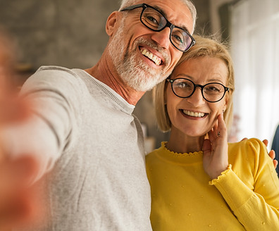 Mature senior caucasian couple husband and wife hold mobile phone and do self portrait hol