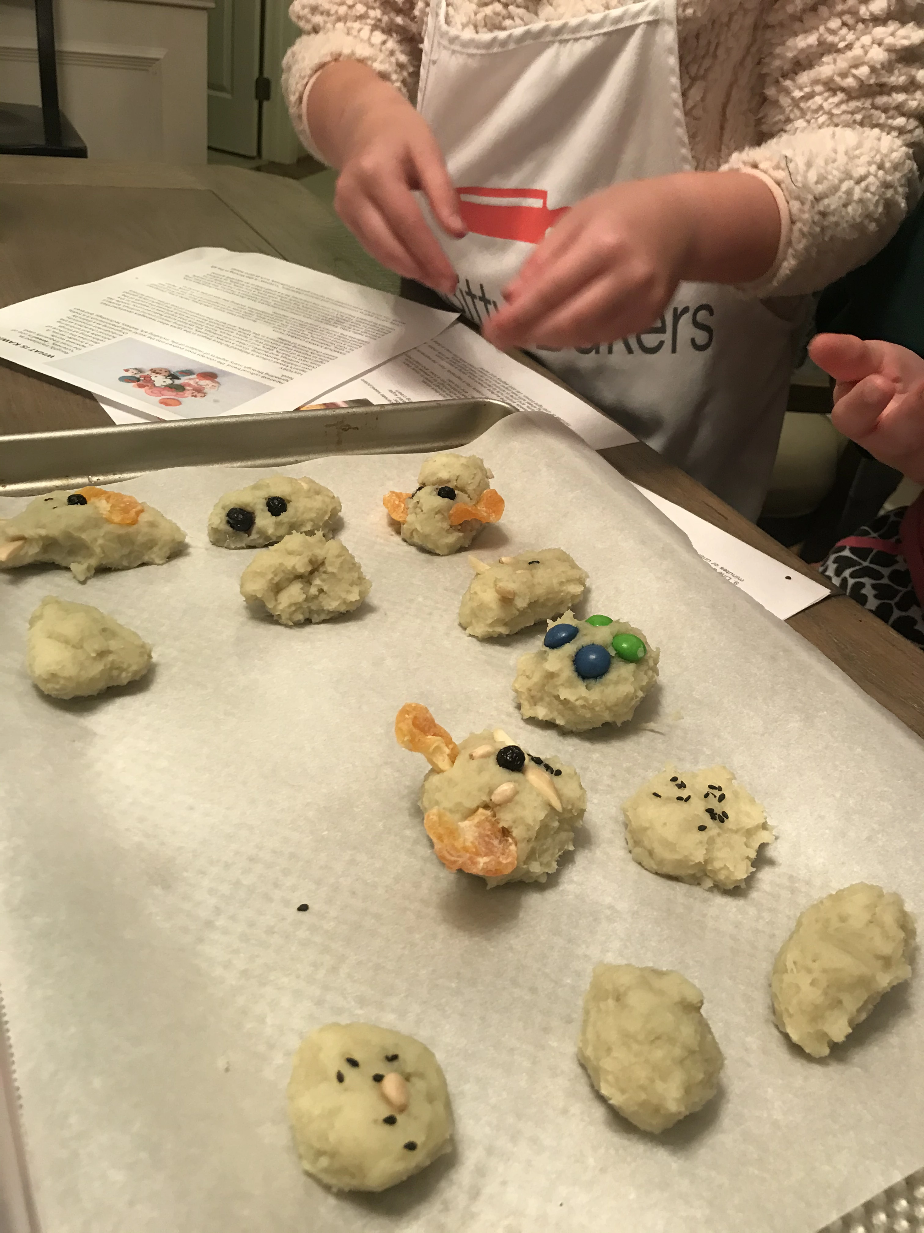 students form the cakes and placing them on the cookie sheet to bake.