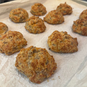 sausage biscuit bites also called sausage balls baked and cooling on a cookie sheet