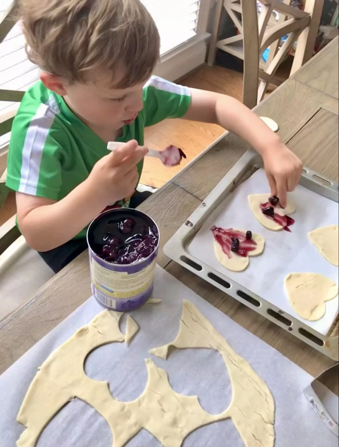 Hearts going on cookie sheet with a dab of filling