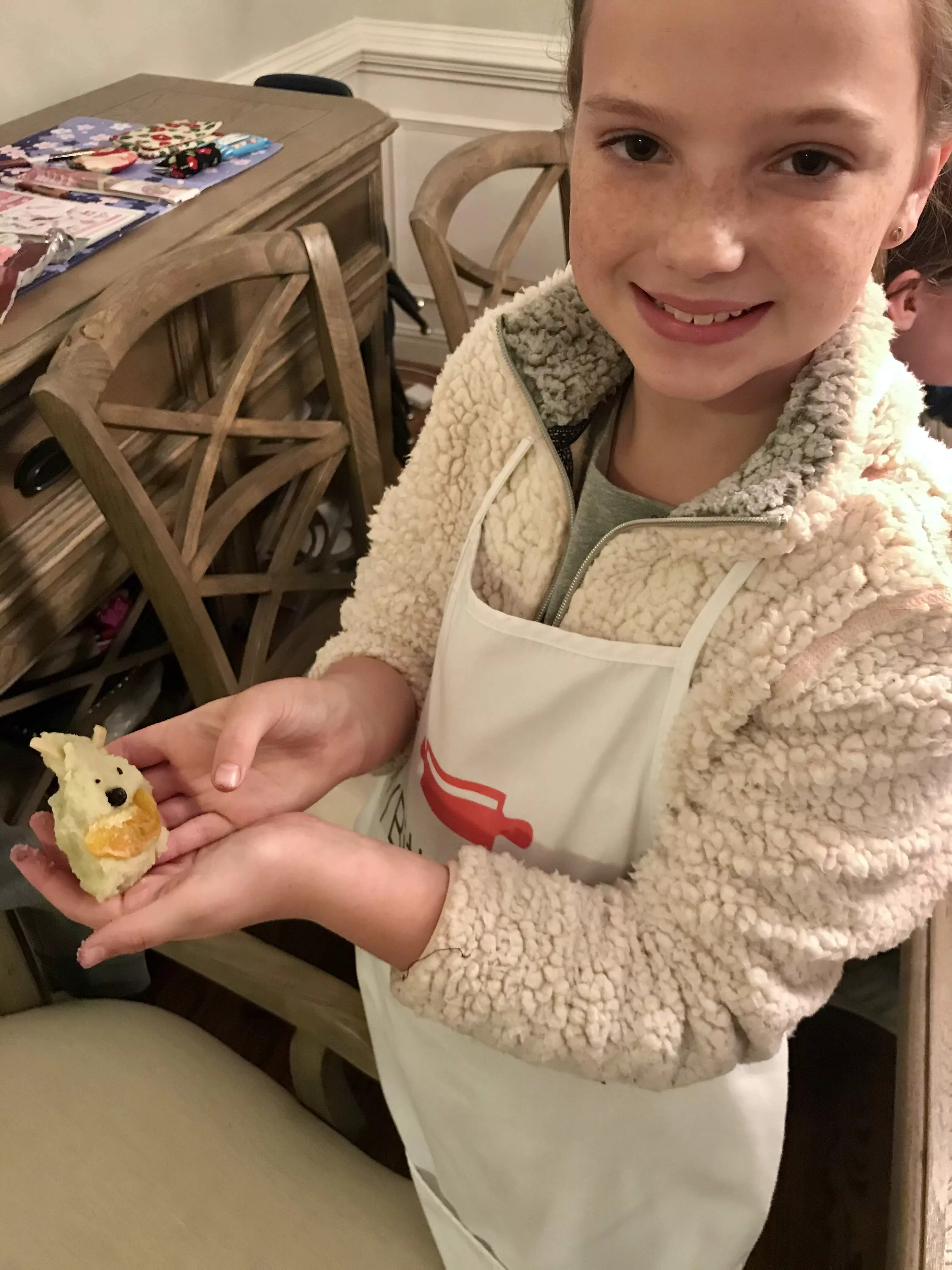 teen girl holds an unbaked sweet potato cake