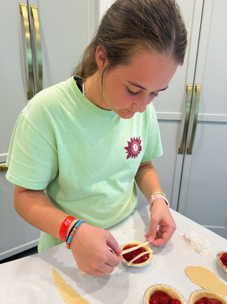 teen girl stands at kitchen counter making latte pie crust