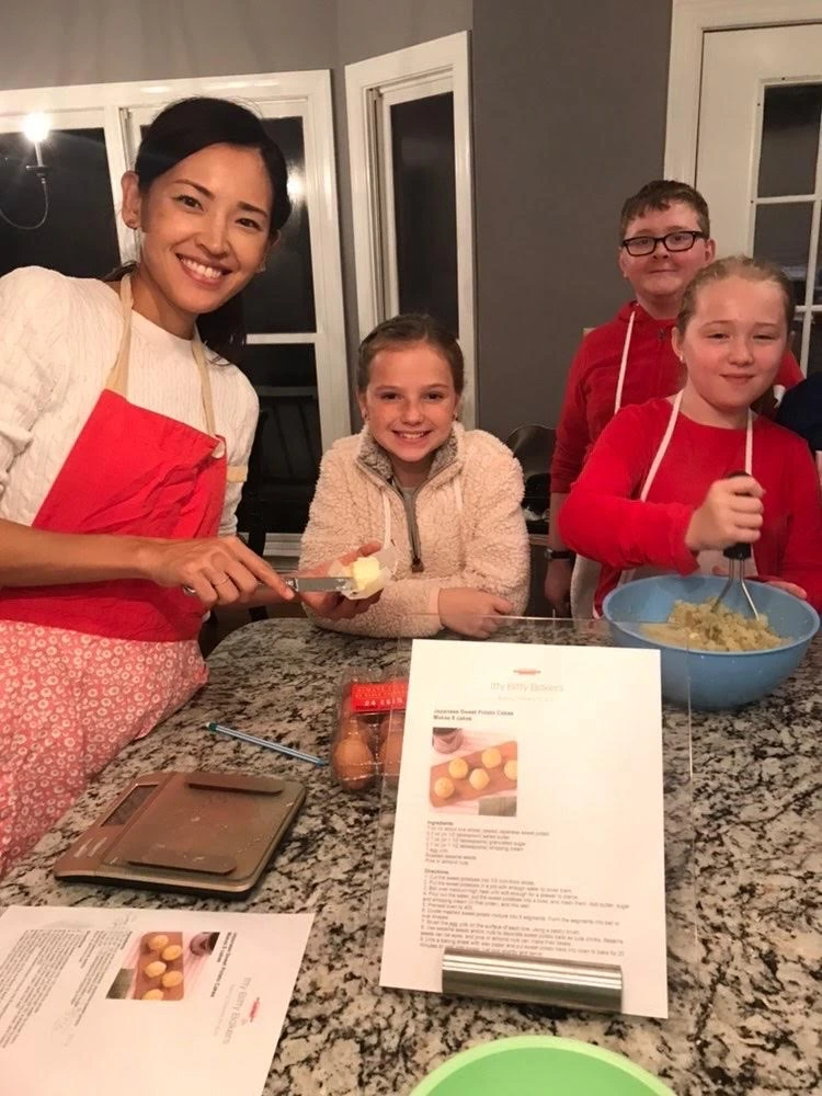 woman with preteen students discussing the recipe and design.