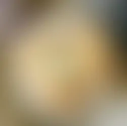 Heart-shaped pastry on a white plate, wooden table background. Nearby, a can reads "berry." Cozy kitchen vibe with a checkered cloth.