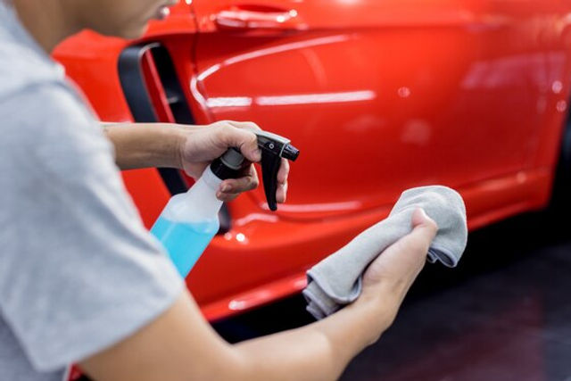 Machine polishing a car panel at the MintGroom studio