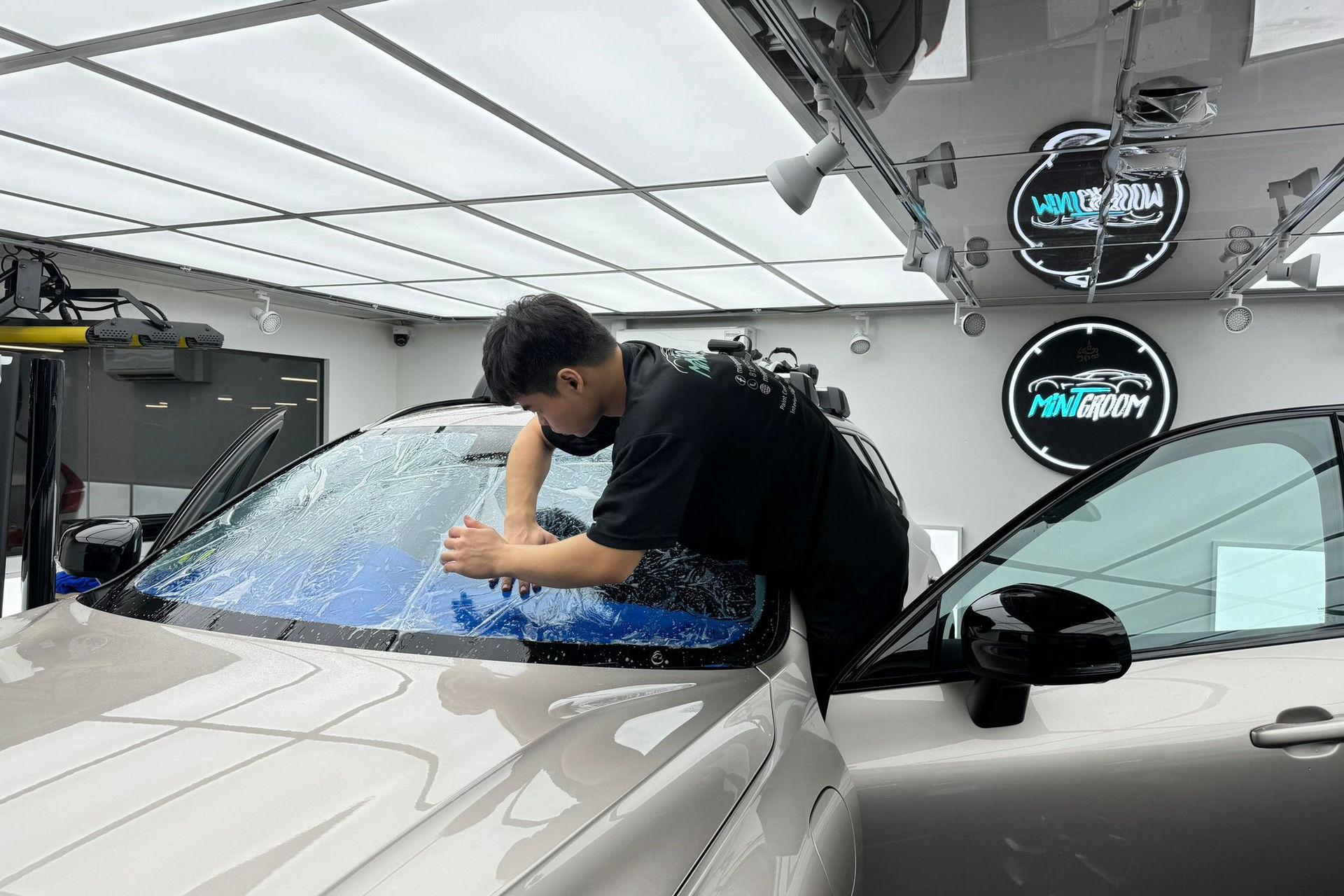 Solar film being installed on a car window at MintGroom