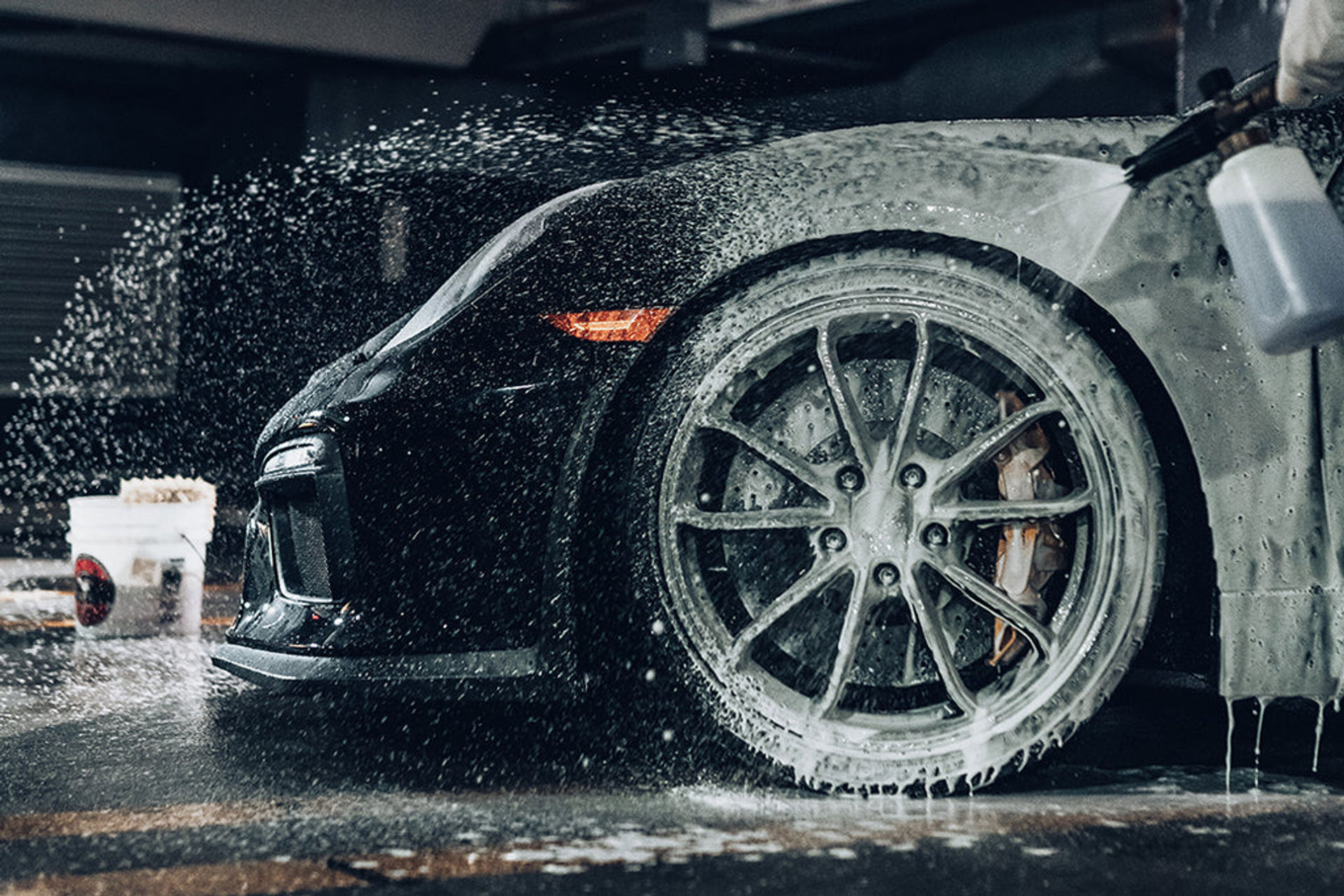 MintGroom technician hand-washing a car with a soft mitt