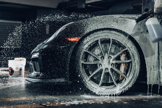 MintGroom technician hand-washing a car with a soft mitt