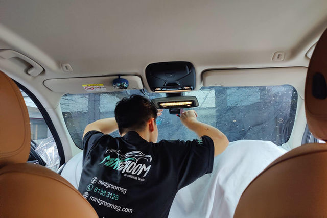 Window tinting film applied to a car's side glass