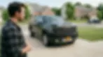 guy-admiring-detailed-gmc-denali-in driveway.webp