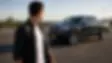 man-walking-away-from-recently-ceramic-coated-gmc-denali-looking-back-over-shoulder.webp