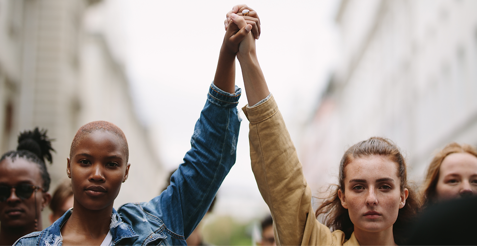 Black and white women holding hands in act of solidarity.