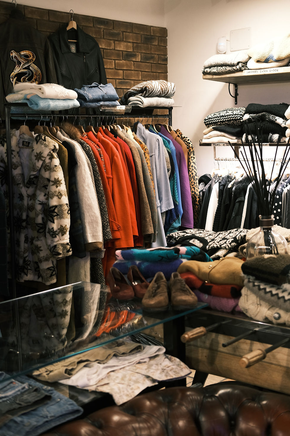 Store with various store displays of vintage clothes, including wool sweaters.