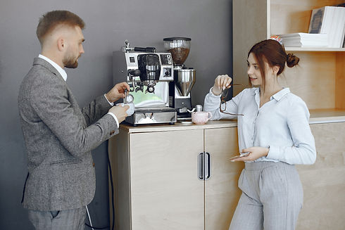 business-man-woman-office-coffee-break-hallway-big-corporation_web.jpg