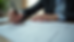 Close-up view of a person writing notes next to a printed Cognitive Flexibility Inventory form