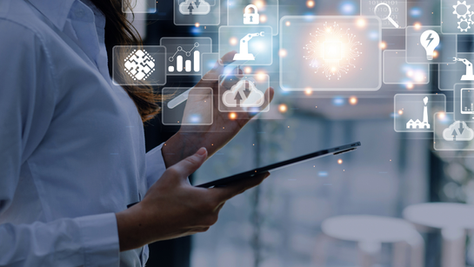 Person in a white shirt uses a tablet, with glowing tech icons floating in a blurred indoor setting. Image conveys order in the chaos.