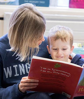 mother-and-son-reading-together-in-library.jpg