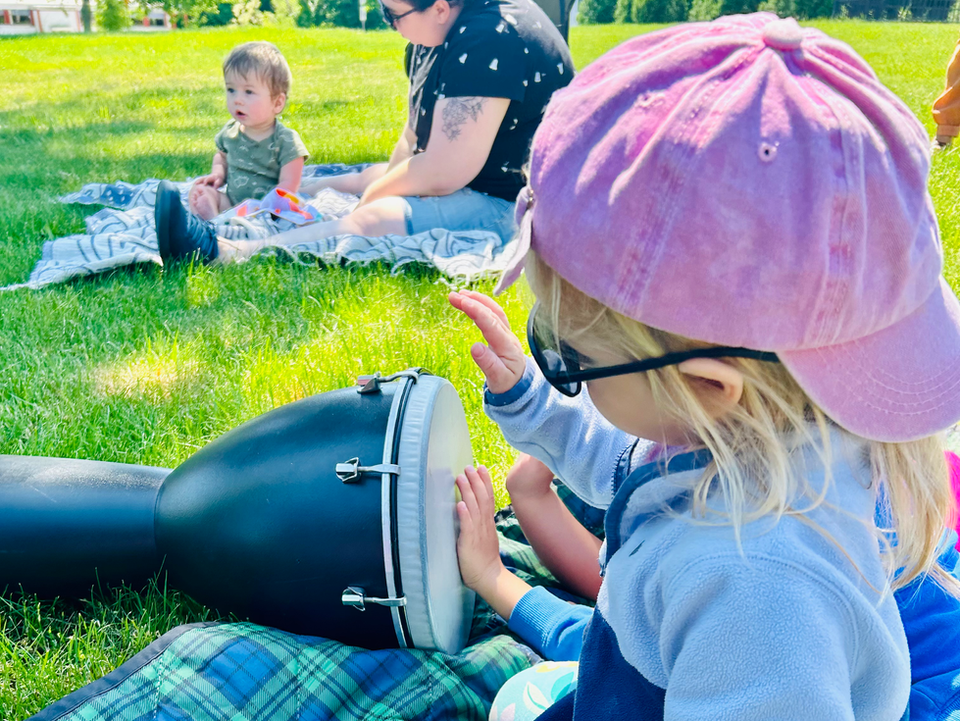 Child playing drum at West End Boston music classes for kids