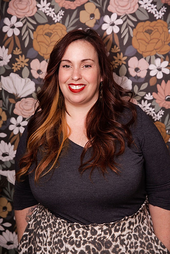 floral wallpaper, salon owner smiling