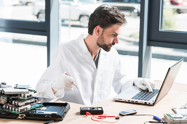 young-male-technician-using-laptop-workshop.jpg