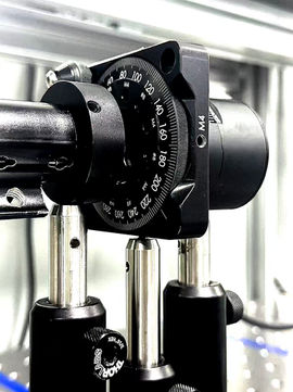 High-precision rotary optical mount used for polarization-maintaining laser adjustment.