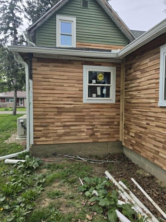 House remodeling with new wood siding done by Precision Roofing And Remodeling