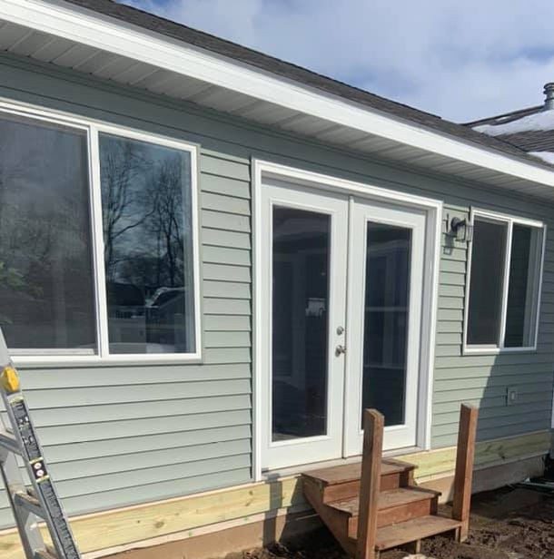 Green siding installation done by Precision Roofing And Remodeling
