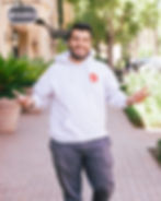 Smiling man in a white hoodie by a dating profile photographer