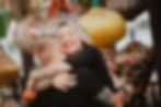 Laughing woman hugging man by a couples photographer.