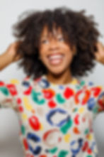 Smiling woman with curly hair from a photography portfolio orange county.