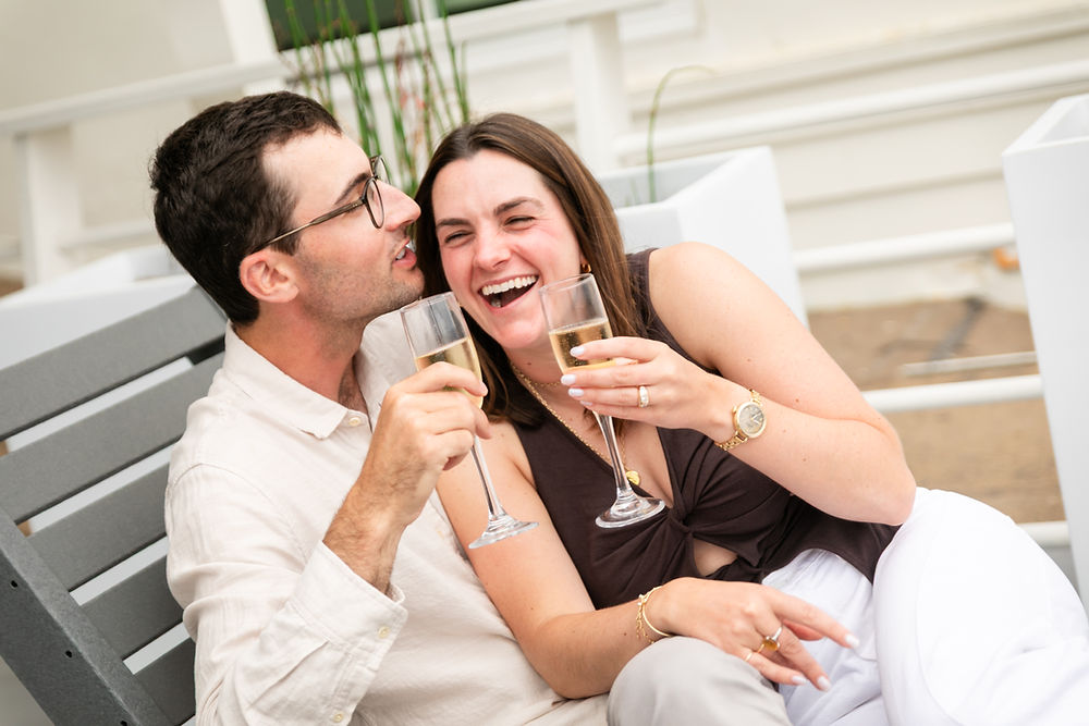 Couple toast with champagne by a couples photographer.